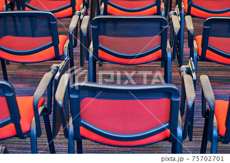 Red and black conference chairs in the auditorium Red and black conference chairs in the auditorium 75702701