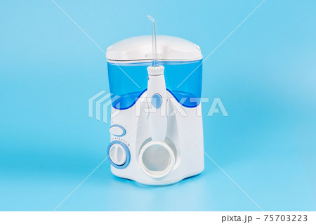 Electronic Tooth Irrigator for personal home usage on blue background. 75703223