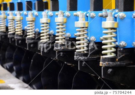 Spring system of agricultural seeder close up Spring system of agricultural seeder close up 75704244