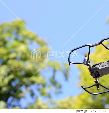 Drone with photocamera take off from land and flying for take aerial photo Drone with photocamera take off from land and flying for take aerial photo 75705095