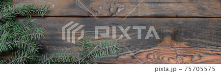 Tree branch on rustic wooden background used for christmas decoration Tree branch on rustic wooden background used for christmas decoration 75705575