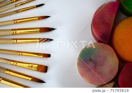 Color cosmetics, brushes and sponges for face painting on white background 75705619