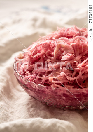 Sour cabbage served in a glass bowl on a rustic tablecloth 75706184