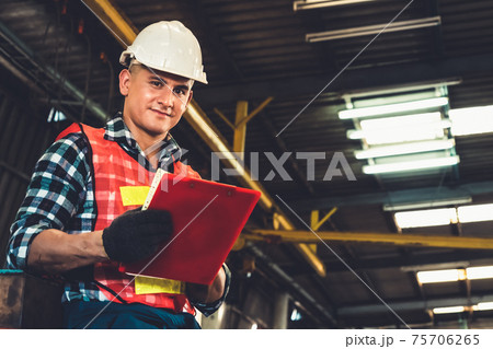 Manufacturing worker working with clipboard to do job procedure checklist . Manufacturing worker working with clipboard to do job procedure checklist . 75706265