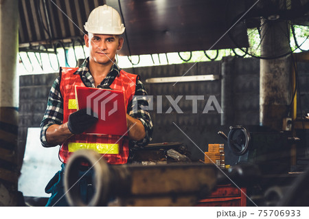Manufacturing worker working with clipboard to do job procedure checklist . Manufacturing worker working with clipboard to do job procedure checklist . 75706933