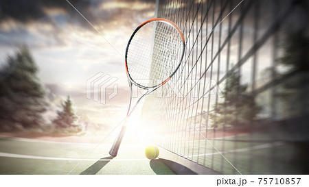 Tennis racket and ball on the outdoor tennis court. Sunset. Tennis. Sport 75710857