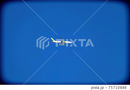 Wide-body plane, with twin turbo engines flies through an impeccable blue sky, 75710886