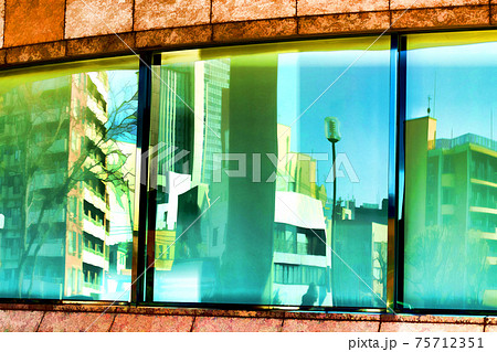 Reflections of buildings in the window panes of another. Reflections of buildings in the window panes of another. 75712351