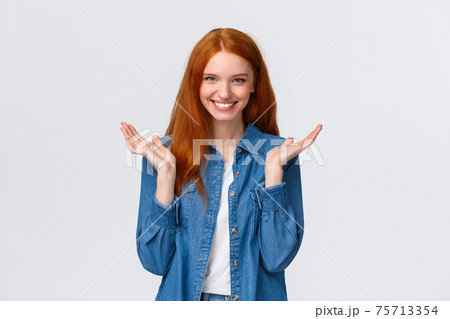 Bravo, very good. Impressed alluring smiling happy redhead woman, wear denim shirt, clap hands, applause and grinning joyfully, pleased with awesome performance, standing white background praising 75713354