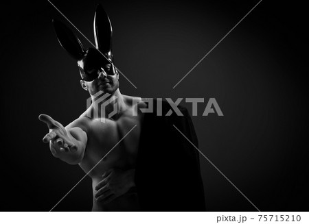 Naked topless muscular man in black rabbit mask Naked topless muscular man in black rabbit mask 75715210