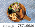 Set of fried salmon steak served on wooden plate 75716680