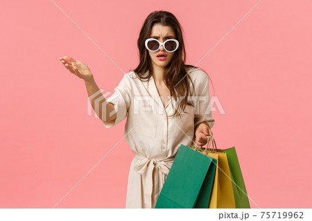 Thats total trash, wtf. Disappointed and bothered sassy glamour young shoppaholic, woman in dress holding shopping bags, pointing at something disgusting, show condemn or scorn Thats total trash, wtf. Disappointed and bothered sassy glamour young shoppaholic, woman in dress holding shopping bags, pointing at something disgusting, show condemn or scorn 75719962
