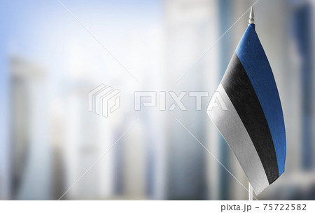 A small flag of Estonia on the background of a blurred background A small flag of Estonia on the background of a blurred background 75722582
