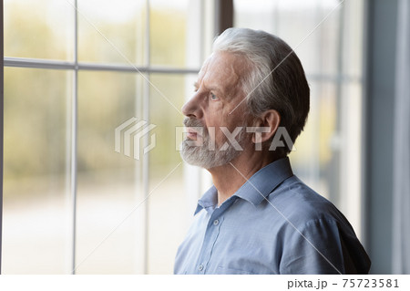 Unhappy older man look in distance feeling lonely Unhappy older man look in distance feeling lonely 75723581