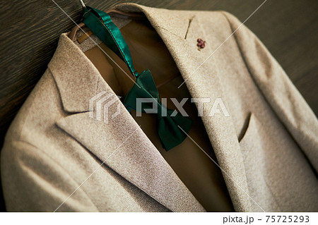 Hanging groom clothes hanger in the room, A man jacket on hanger at the hotel room 75725293