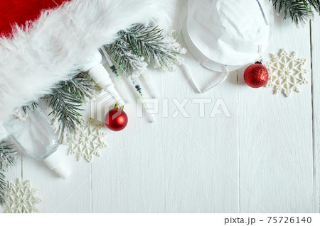 Christmas medical coronavirus flat lay, protective face mask, pills, antiseptics, decoration on white background Christmas medical coronavirus flat lay, protective face mask, pills, antiseptics, decoration on white background 75726140