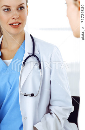 Woman - doctor consults her female patient in clinic. Medicine concept 75726380