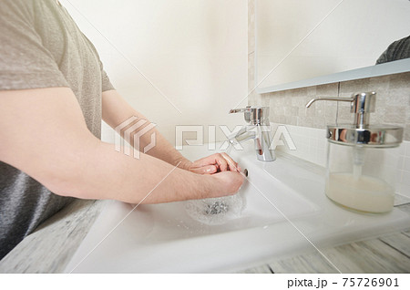 Wet hands under sink Wet hands under sink 75726901