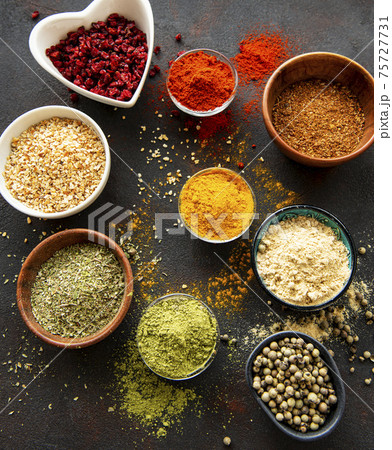 Colorful and aromatic herbs and spices on a dark background 75727731