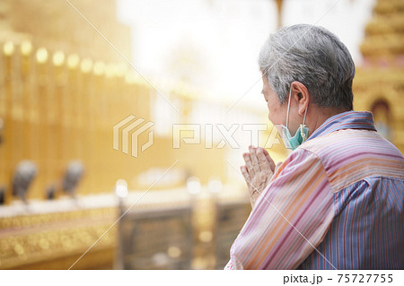 old asian senior woman traveler tourist praying at buddhist temple. old asian senior woman traveler tourist praying at buddhist temple. 75727755