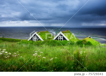 Old historic houses on the field in Iceland. Natural Icelandic background. Travelling on Iceland. Old historic houses on the field in Iceland. Natural Icelandic background. Travelling on Iceland. 75729341