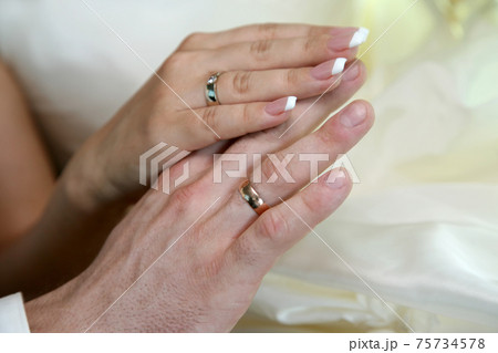 hands of the bride and groom together hands of the bride and groom together 75734578