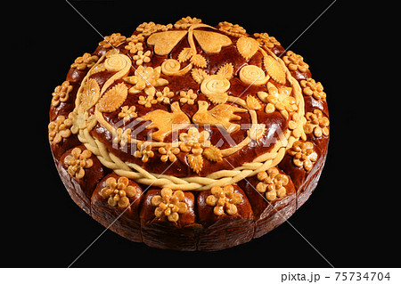 large round loaf with ornament on black background large round loaf with ornament on black background 75734704