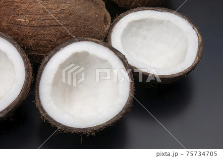 cut fresh coconut on a dark background. vitamin fruits. healthy food 75734705
