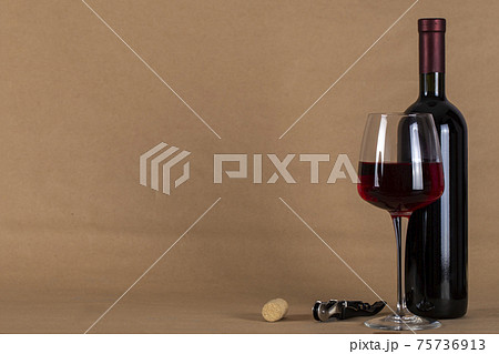 Wine bottle and glass . Space for text. 75736913