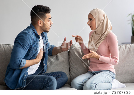 Emotional muslim man and woman fighting at home Emotional muslim man and woman fighting at home 75737359