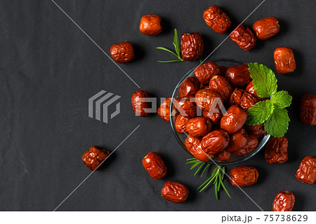 Dried Jujube, Chinese dried red date fruit with Mint leaves in glass cup and rosemary leaf Dried Jujube, Chinese dried red date fruit with Mint leaves in glass cup and rosemary leaf 75738629