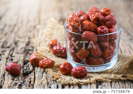 Dried Jujube, Chinese dried red date fruit in glass cup on old wood background, Dried Jujube, Chinese dried red date fruit in glass cup on old wood background, 75738679