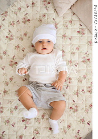 Portrait of a crawling baby on the bed in her room. 75738743