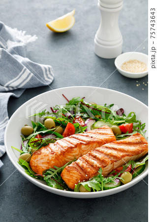 Grilled salmon fillet and fresh vegetable salad. Mediterranean diet. Grilled salmon fillet and fresh vegetable salad. Mediterranean diet. 75743643