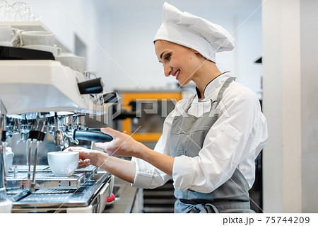 Woman in coffee shop preparing espresso powder 75744209