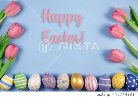 Pink tulips flowers and colourful eggs on pink background. Card for Happy Easter. Waiting for spring. Pink tulips flowers and colourful eggs on pink background. Card for Happy Easter. Waiting for spring. 75744331