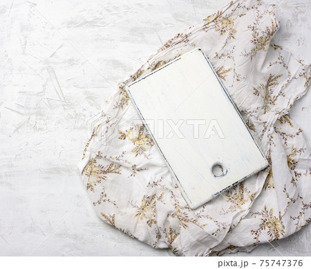 rectangular white cutting board on white textile tablecloth 75747376
