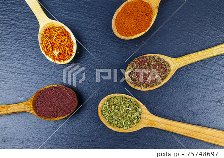 Set of different aromatic spices on black slate. Top view Set of different aromatic spices on black slate. Top view 75748697