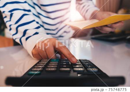 Business hands holding saving account passbook with calculator, Business hands holding saving account passbook with calculator, 75748775