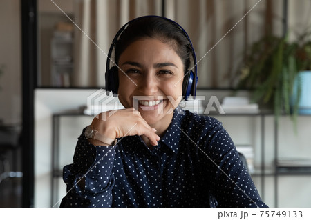 Headshot of smiling Indian woman talk on video call 75749133