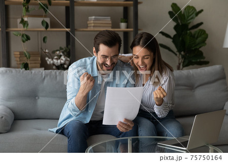 Overjoyed young couple reading good news in letter, celebrating success Overjoyed young couple reading good news in letter, celebrating success 75750164