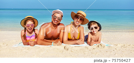Loving family spending day on beach Loving family spending day on beach 75750427