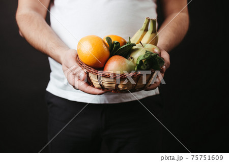 Healthy vegetarian food. Fat man with fresh fruits 75751609