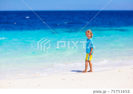 Kids playing on beach. Children play at sea. Kids playing on beach. Children play at sea. 75751658