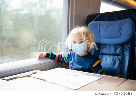 Kids travel by train in face mask. Virus outbreak. Kids travel by train in face mask. Virus outbreak. 75751665