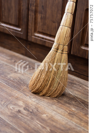 Cleanliness and order at home, a broom of sorghum for sweeping is on the floor against the wall, cleaning equipment, routine household chores 75757072