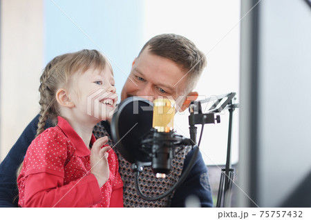 Man and girl are recording their voice on microphone 75757432