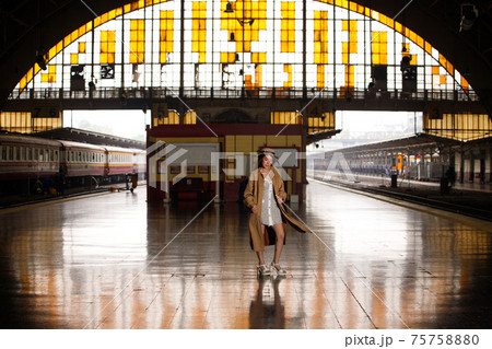 Young model travels on train at station railway in Summer 75758880