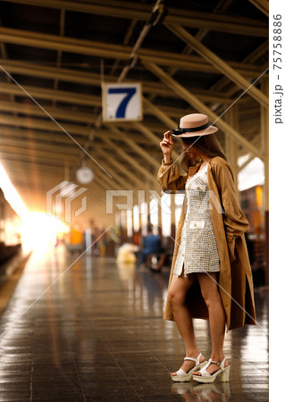 Young model travels on train at station railway in Summer 75758886