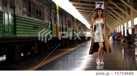 Young model travels on train at station railway in Summer Young model travels on train at station railway in Summer 75758888